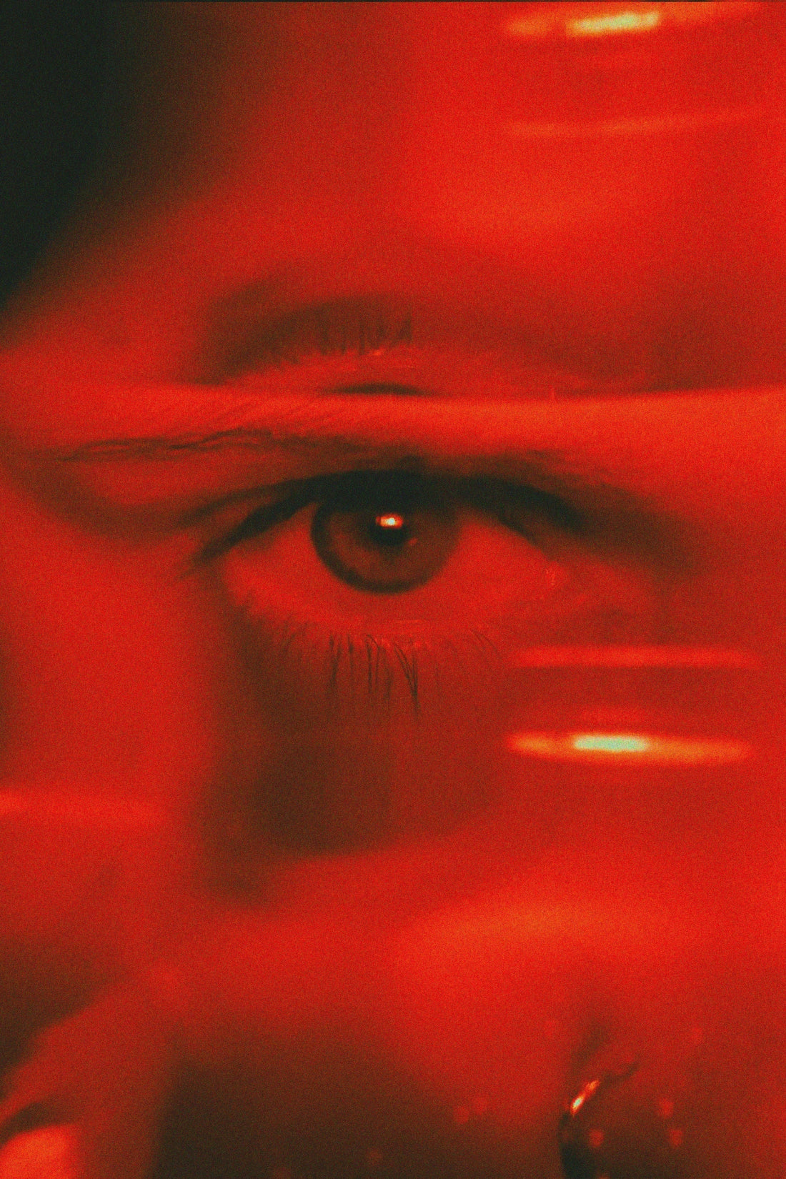 an eye of a woman in red light 