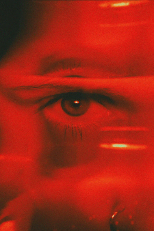 an eye of a woman in red light 