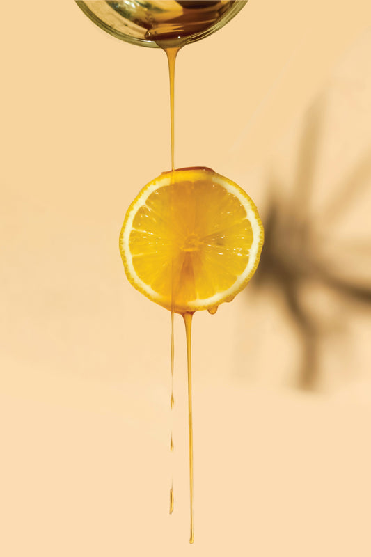 Bright orange dripping in honey shaped by natural sunlight exposure