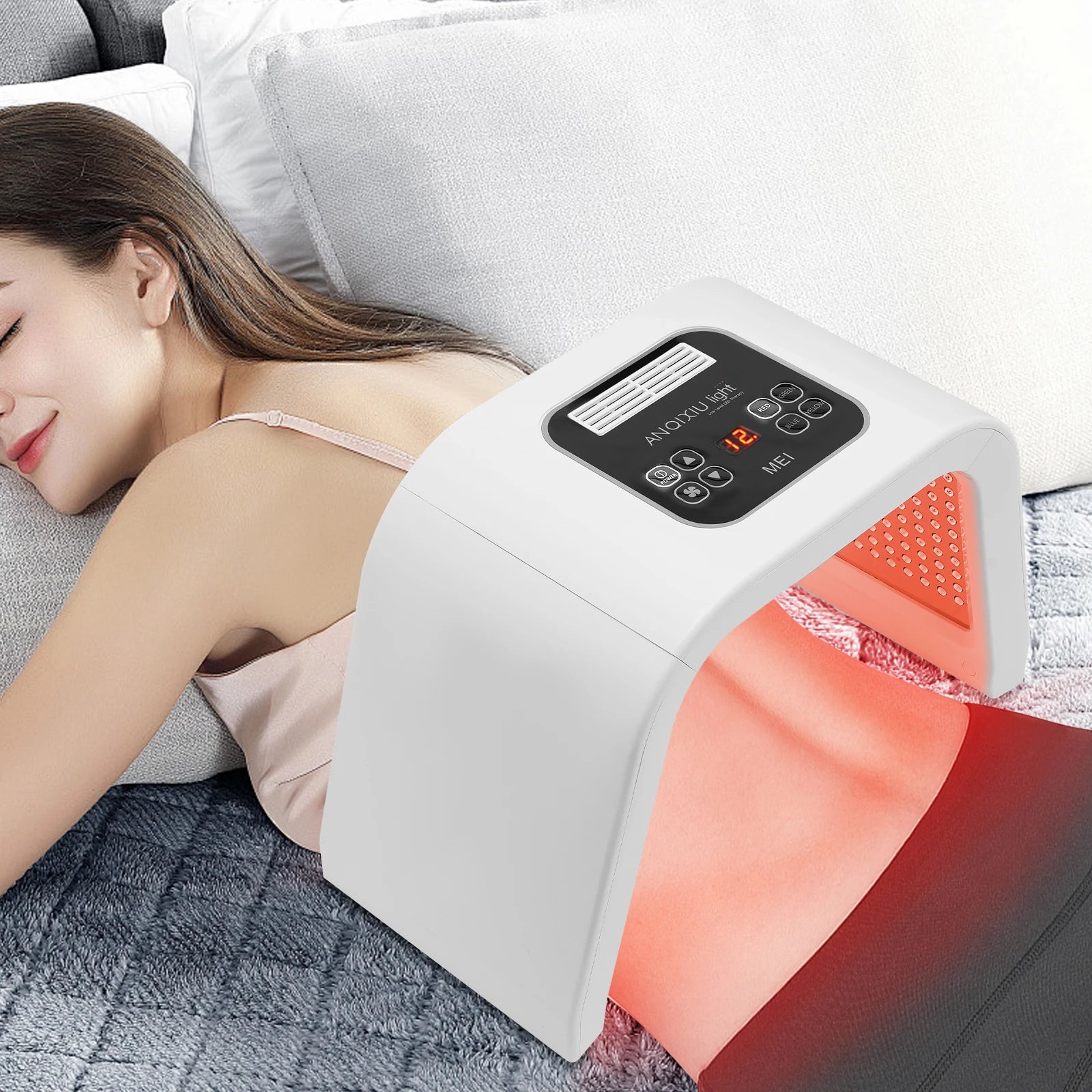 A woman is using Maison Infrared Multi-Spectrum LED Light Therapy Device for Radiant Skin Renewal on her back